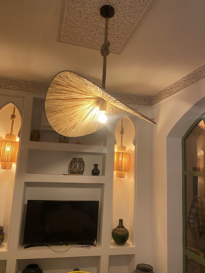 Asymmetric raffia pendant light with handmade curved canopy shade