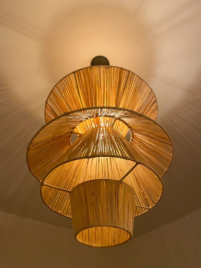 Handmade tiered raffia pendant light with layered sculptural design