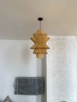 Handmade tiered raffia pendant light with layered sculptural design