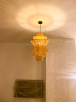 Handmade tiered raffia pendant light with layered sculptural design