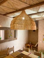 Oversized raffia pendant light with handmade Moroccan wavy dome shape