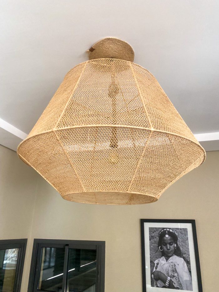Handmade raffia pendant light with wide flared woven shape