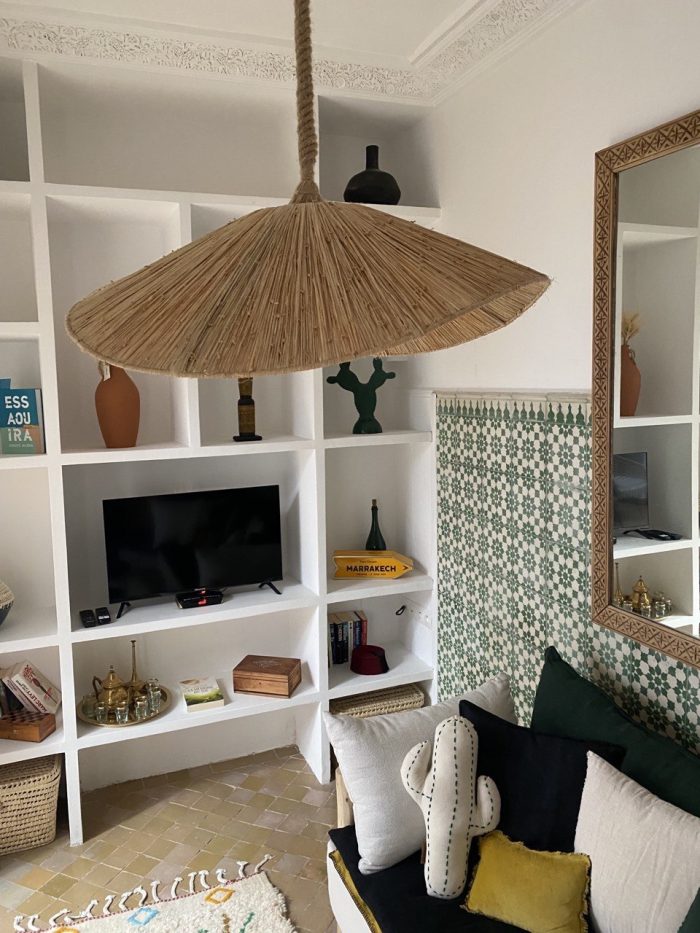 Asymmetric raffia pendant light with handmade curved canopy shade