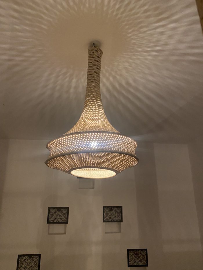 Handmade rope pendant light with long neck and tiered circular shape