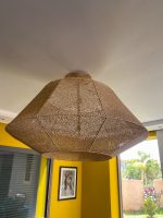 Handmade raffia pendant light with wide flared woven shape