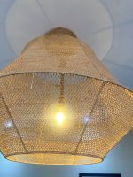 Handmade raffia pendant light with wide flared woven shape