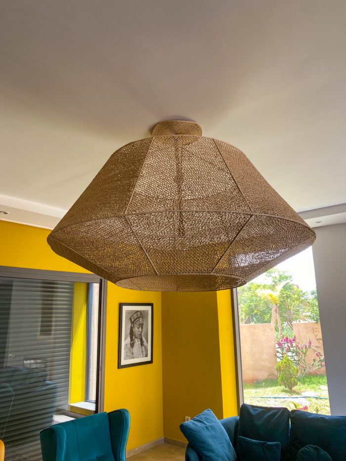 Handmade raffia pendant light with wide flared woven shape