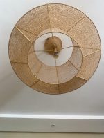 Handmade raffia pendant light with wide flared woven shape