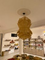 Spiral raffia pendant light with cascading handwoven layers