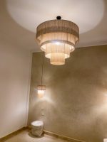 Cascading fringe chandelier with layered natural fiber drum shades