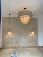 Cascading fringe chandelier with layered natural fiber drum shades