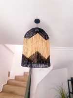 Black and natural bell raffia pendant light with geometric woven design