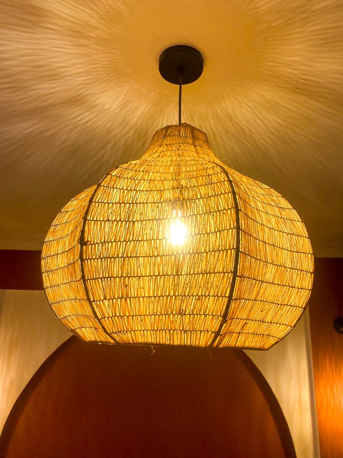 Sculptural raffia pendant light with rounded handmade Moroccan woven shade