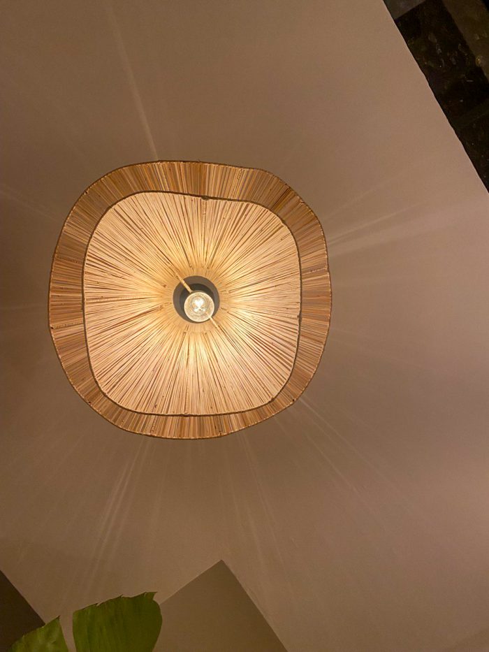 Handmade wavy flower raffia pendant light with layered natural woven petals