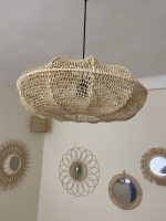 Sculptural Raffia Pendant Light handmade from natural woven raffia with a structured metal frame.