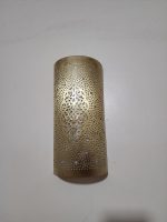 Handmade Moroccan pierced brass wall lamp with perforated pattern and warm up and down lighting.