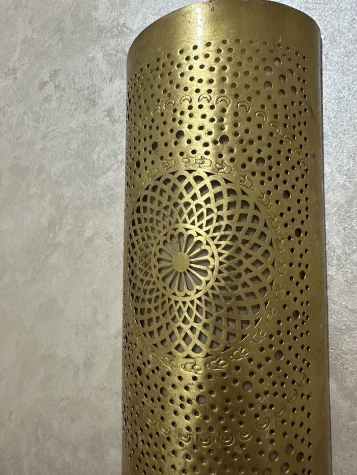 Handmade radiant rosette brass wall sconce with central geometric floral medallion and pierced decorative pattern.