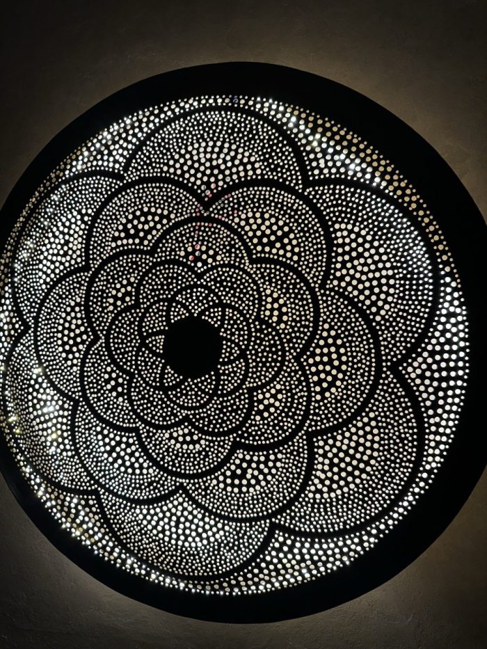 Moroccan Brass Flower Wall Light with handmade pierced rosette pattern and warm decorative glow