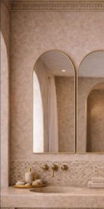 Set of 3 handmade arched brass wall mirrors with slim solid brass frames above a double bathroom vanity.