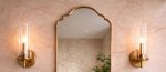 Scalloped Arch Brass Mirror above brass vessel sink and green tiled bathroom wall