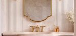 Crown Curve Brass Mirror above wood vanity with green tiled bathroom wall