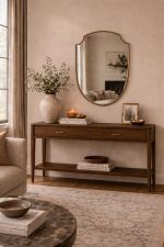 Curved Shield Brass Mirror displayed above entryway console with slim brass frame