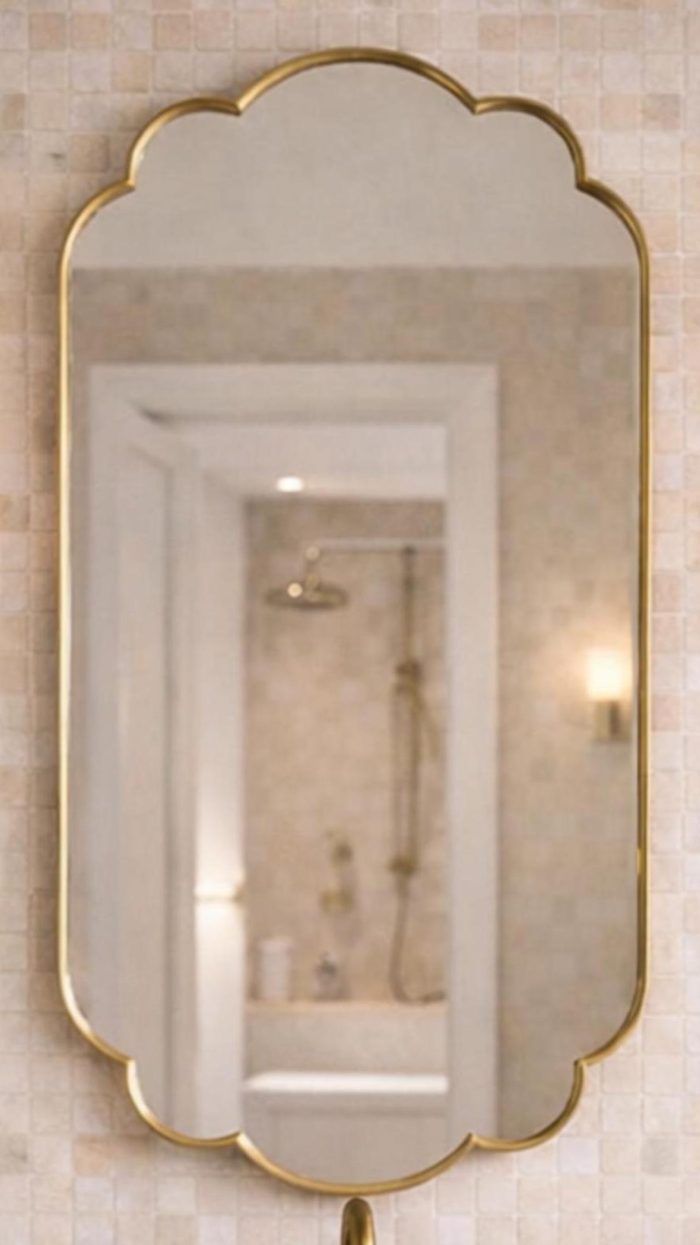 Handmade Moroccan Scalloped Brass Mirror with decorative floral shape above bathroom vanity