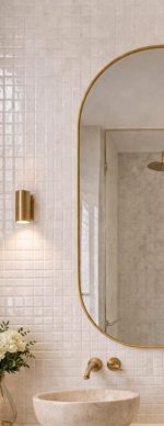 Handmade rounded arch brass wall mirror with solid brass frame above a double bathroom vanity.