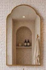 Handmade Arched Brass Vanity Mirror styled with brass sconces and bathroom vanity