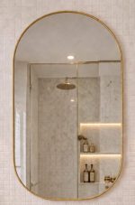 Handmade rounded arch brass wall mirror with solid brass frame above a double bathroom vanity.