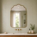 Handmade brass bathroom mirror with cloud arch top and slim brass frame