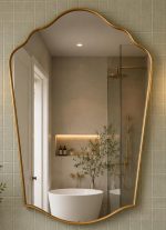 Handmade Scalloped Crown Brass Mirror above wood vanity with brass fixtures