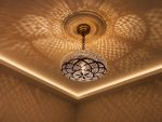 Globe Moroccan Brass Pendant Light casting decorative patterned shadows across ceiling
