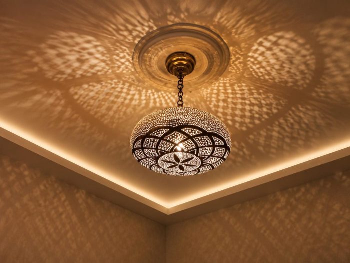 Globe Moroccan Brass Pendant Light casting decorative patterned shadows across ceiling