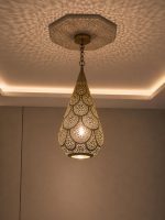 Teardrop Moroccan Brass Pendant Light handmade pierced brass hanging lamp casting decorative ceiling shadows